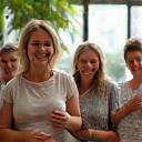Diverse group of adults smiling and interacting in a bright, modern community space, symbolizing community support.